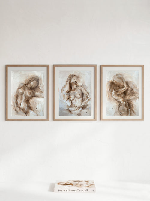 Neutral triptych of figurative oil paintings on a warm wall