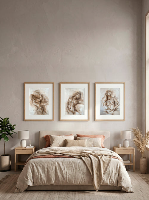 Beige oil painting set of three above a bed, neutral bedroom