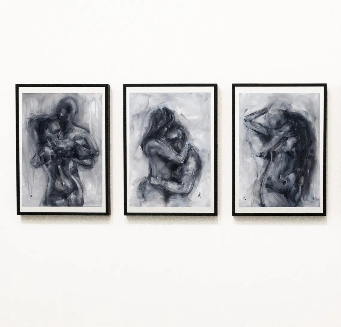 Three monochrome figure prints as a gallery triptych on a white wall