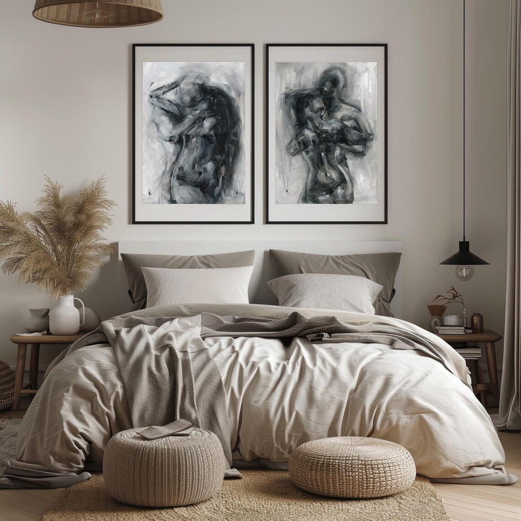 Set of two charcoal prints of figures embracing, framed above a bed