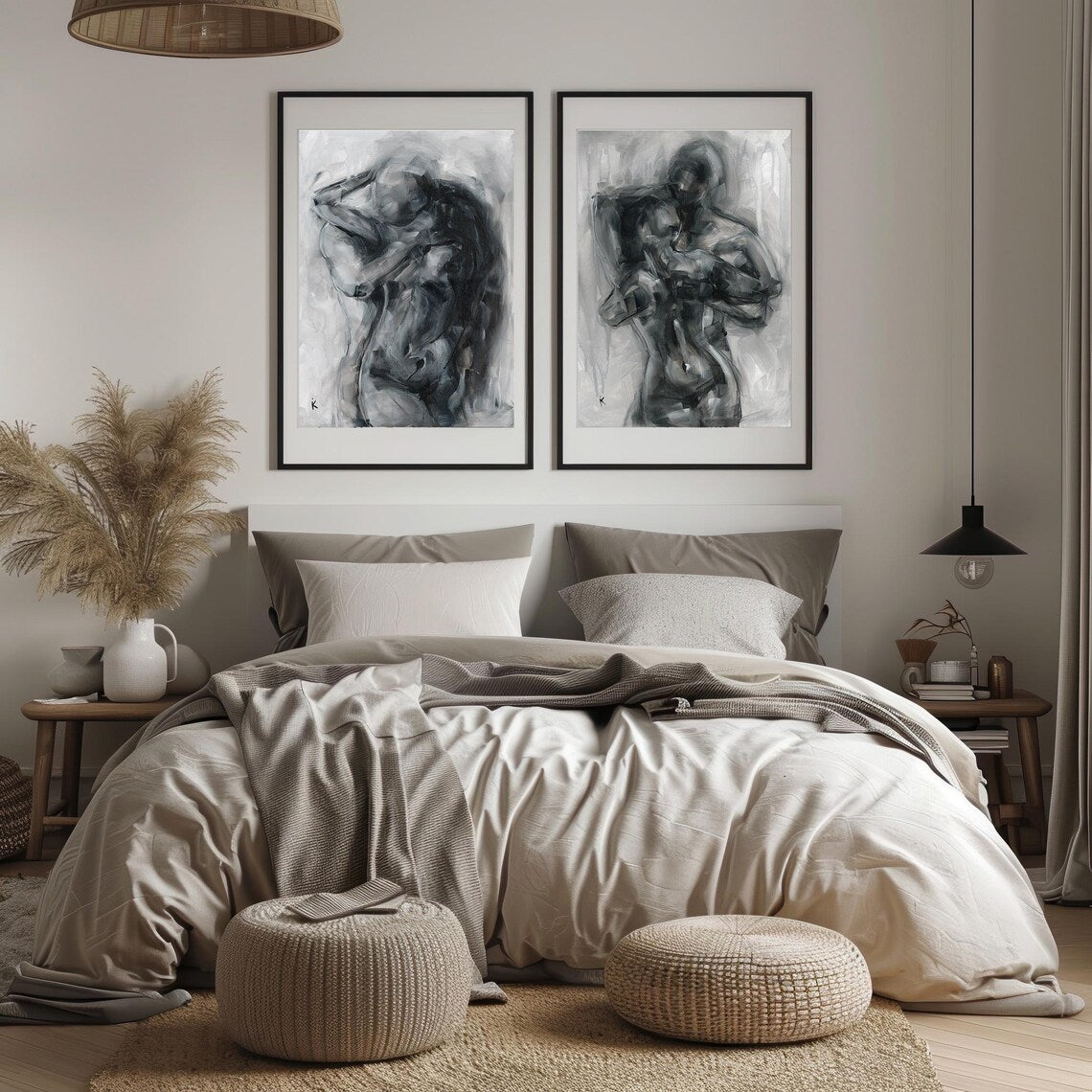 Set of two charcoal prints of figures embracing, framed above a bed